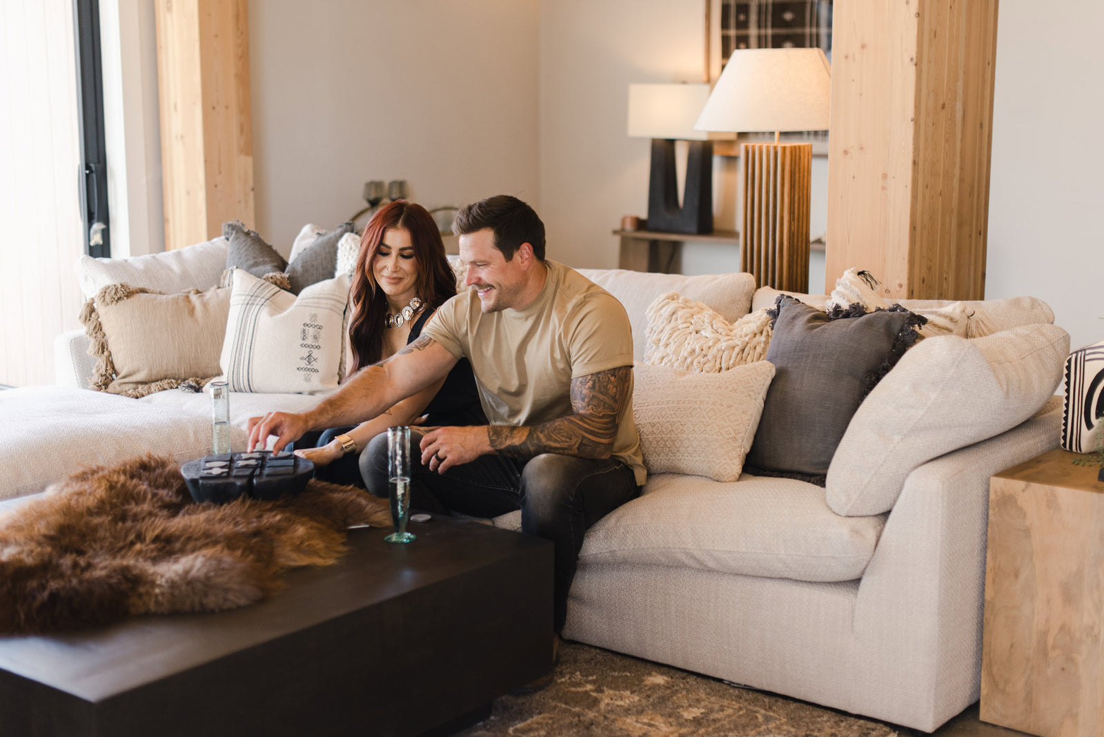 Cole and Chelsea DeBoer sitting on couch playing a game