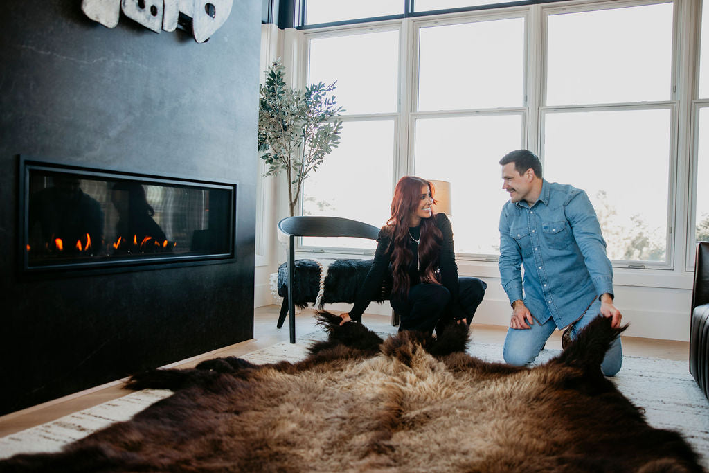 Cole and Chelsea DeBoer arranging rug in house