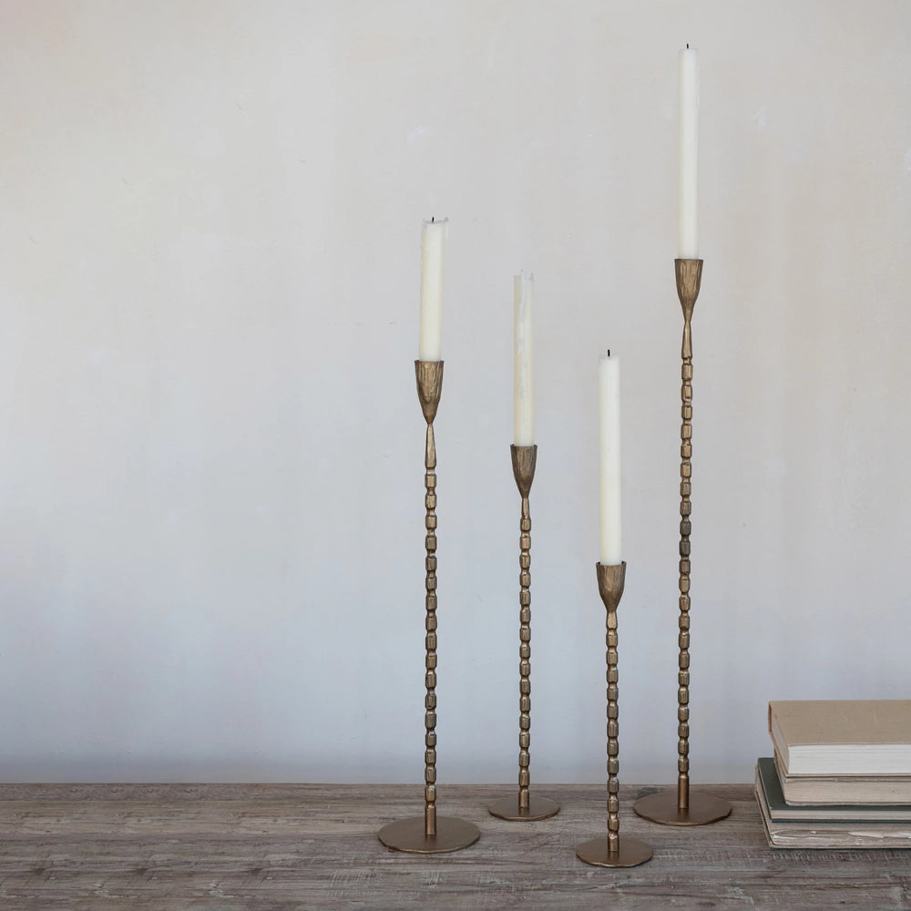 Beaded Tapers with white candles arranged on stand