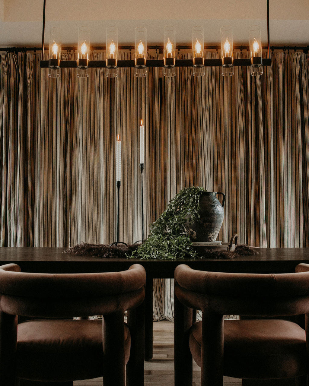 Table and chairs in front of curtain